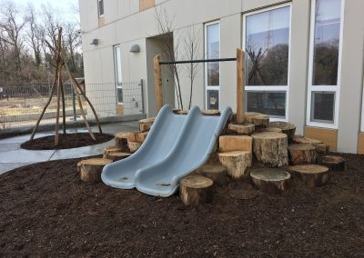 Embankment slide set into a constructed toddler hill