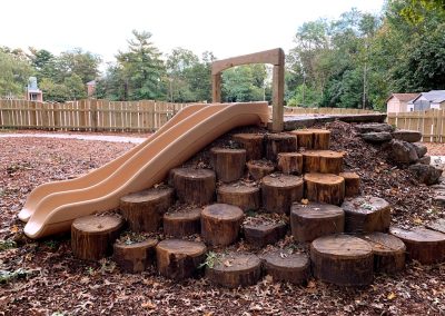 This constructed hill with an embankment slide provides lots of ways to climb up on stumps and boulders.